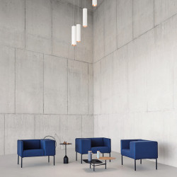 Design armchair Brix with wide armrest by Viccarbe - Blue on a black base in a diaphanous space| Aiure
