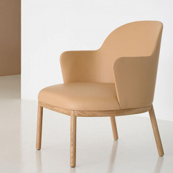 Aleta wooden design armchair with armrests by Viccarbe in a lounge| Aiure