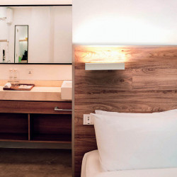 Hanok white-coloured linear wall lamp by Mantra on the headboard of a bed| Aiure