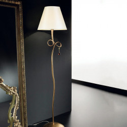 Paola floor lamp by Viccarbe, gold finish in a living room| Aiure