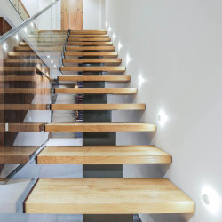 Close-up of the Led Wall Light Alfa on wooden staircase by Arkoslight | Aiure