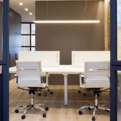 White LED lamp hanging from the ceiling of an office. Slimgot series by Arkoslight | Aiure