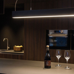 LED pendant lamp installed on the ceiling above a kitchen island. Fifty Suspension series by Arkoslight | Aiure
