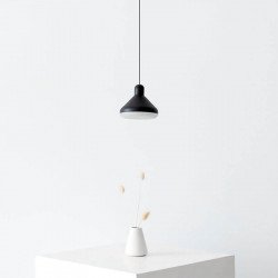 Black pendant lamp over a table with flower. Mantra | Aiure