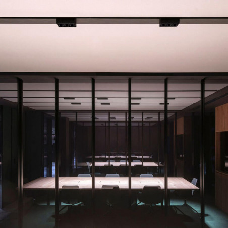 Several black ceiling lamps Black Foster Surface 3 by Arkoslight in an interior room | Aiure