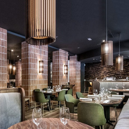 Butaca de diseño Aleta con reposabrazos de Viccarbe en un restaurante| Aiure